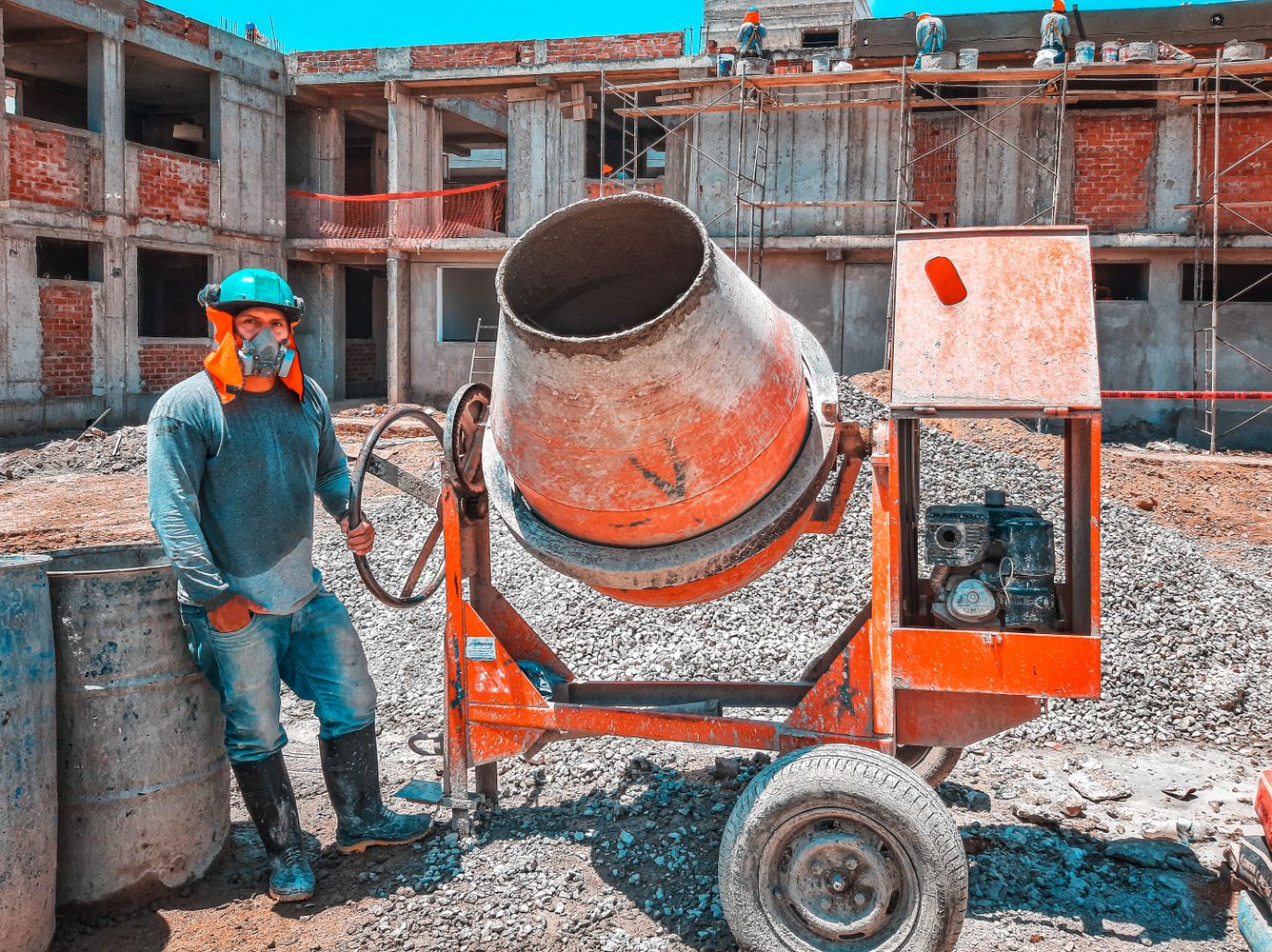 Concrete mason bull floating and troweling slab surface